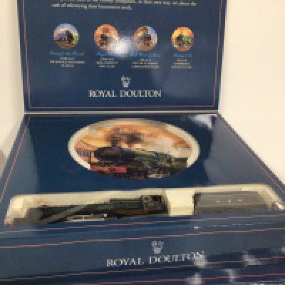 A pair of Royal Doulton commemorative plates made for Hornby Railways each containing a model train. (2)