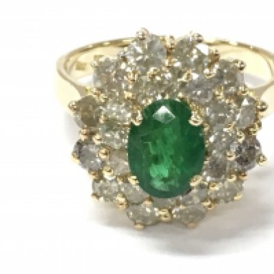 A 14ct gold oval emerald and round cut diamonds in a double halo ring. Emerald 1.05ct and diamond approximately 2.35ct. Size R. Postage B