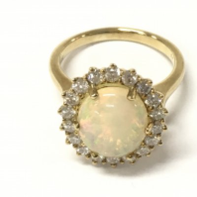 A 9ct yellow gold cluster ring set with an oval cabochon opal surrounded by diamond halo. Opal 2.69vt and diamonds 0.80ct approx. Size O
