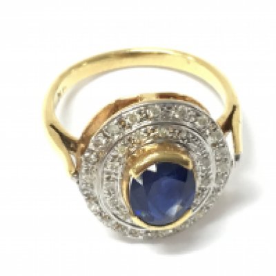 A 9ct gold oval ring semi rubber set with an oval sapphire surrounded by a double halo of diamonds. Sapphire approx 1ct and diamonds 0.40ct Approx. Size M 1/2