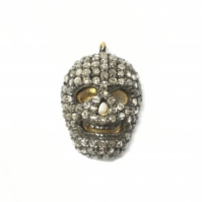 A silver and gold plated diamond set skull pendant. Diamonds 0.65ct Approx and 0.5cm length.