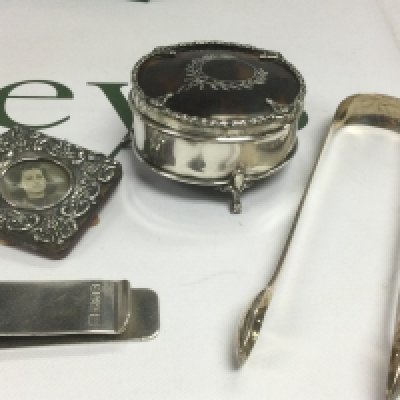 Four silver items comprising a small photo frame, circular box etc. Shipping category B.