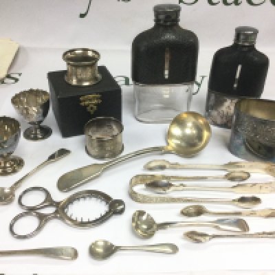 A collection of oddments comprising two hip flasks, napkin rings, silver cutlery, costume jewellery etc. Shipping category D.
