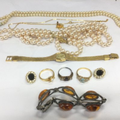 A collection of costume jewellery including a silver and amber bracelet, simulated pearls etc. Shipping category B.