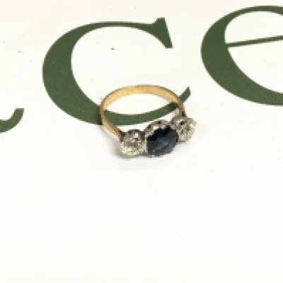 A three stone ring set with two old cut diamonds on the side with an alexandrite set in the centre. Approx weight 3.48 grams, approx size O.