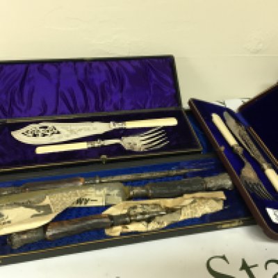 Two cased silver plated fish slice and serving folk sets in a fitted case and horn and silver mounted carving sets. (3)