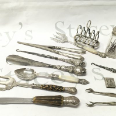 Silver hallmarked and silver plated items including toast rack, Paris book pendant, Glove stretcher, Crochet hook etc. postage category B