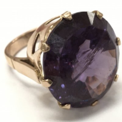 A purple cubic zirconia stone ring, size M. Postage catA