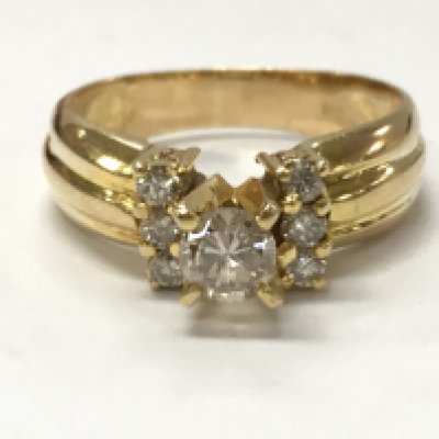 An unmarked 14ct gold diamond solitaire ring with diamond shoulders , size N. 4.5g total weight. Postage category A