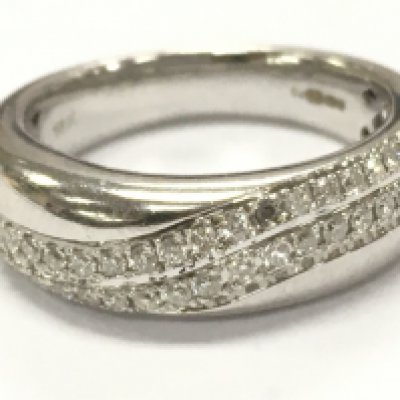 An 18ct white gold diamond band ring, 5.6g total weight. Size K/L. Postage cat A