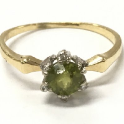 An 18ct gold peridot and diamond ring, size R, 2.8g postage category A
