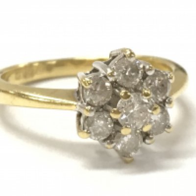 An 18ct gold diamond daisy cluster ring, 1/2ct, size J, 3.1g. Postage category A