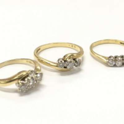 18ct gold three stone diamond rings . Sizes J,K,P 9g total weight. Postage category A
