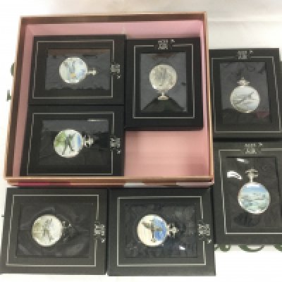Seven boxed pocket watches decorated with images of WW2 aircraft. Shipping category D.