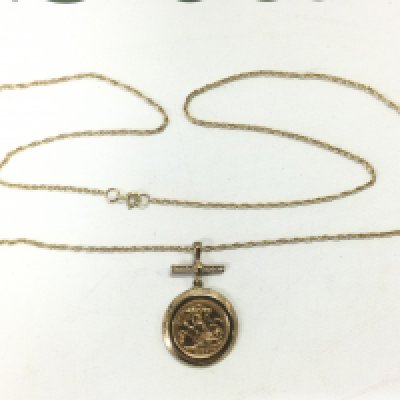 A 2004 gold half sovereign on a chain set with small diamonds, approx 12.7g. Shipping category A.