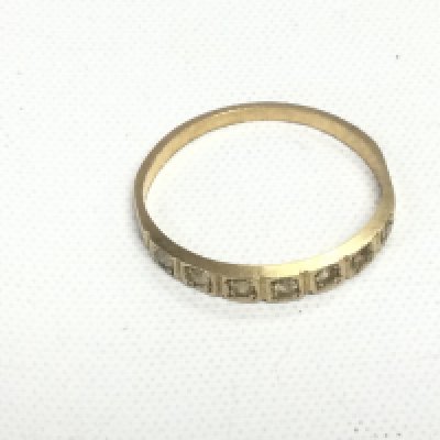 An unmarked yellow metal ring set with clear stones, approx 0.9g and approx size J-K. Shipping category A.