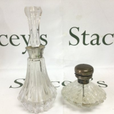 A silver topped perfume bottle plus one other. Shipping category D.