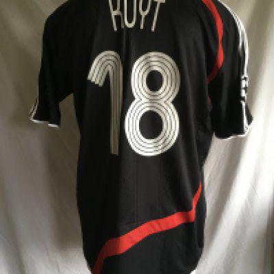 Kuyt Liverpool 2007 - 2008 Rare Champions League Match Worn Football Shirt: Incredibly rare, this shirt was made for Champions League matches. Short sleeve, black with red flash and white stripes to arms. Believed to be worn v Arsenal. Worn by Kuyt whose name and number 18 appear to rear. Champions League patch to arm has number 5 to indicate wins of the trophy. Carlsberg sponsorship. Signed to rear to the left of his name in gold.