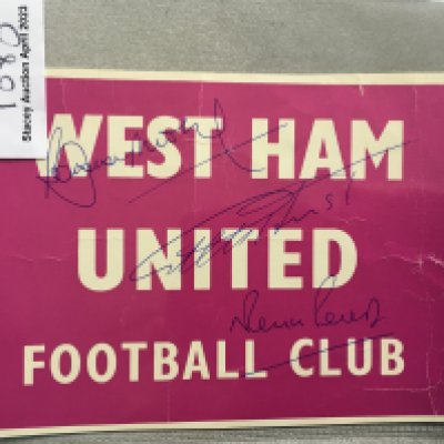 Bobby Moore Double Signed West Ham Sign: Pink and white card stating West Ham United Football Club. Hand signed in biro to front by World Cup winners Hurst Moore and Peters and to rear clearly on white background.