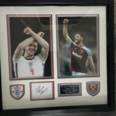 Declan Rice West Ham + England Signed Framed Photo: Beautifully framed item definitely for the West Ham fan. Two separate large photos of Rice in West Ham kit and then in England kit doing the Hammers sign. Nice plaques with colour coordinated double mounting and a white card signed. COA to rear.