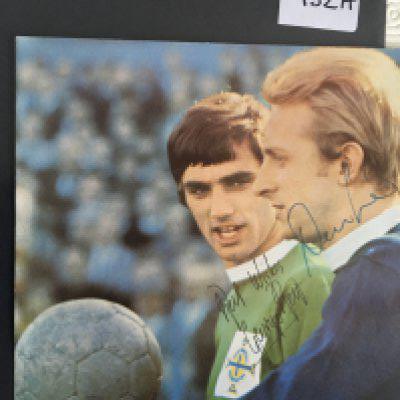 George Best + Denis Law Signed Football Picture: Large colour magazine picture featuring both Manchester United players in their respective Scotland and Northern Ireland kits. Both clearly hand signed without dedication. Measures just over 8 inches square.