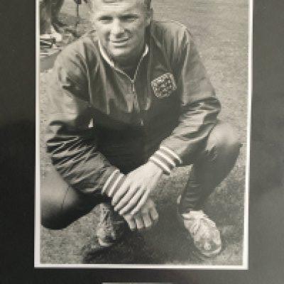 1966 England Full Squad Signed Collection: Small folder with a magazine picture or white card of all the 22 man squad plus manager Ramsey and trainer Shepherdson. Most of the magazine pictures are World Cup related. Bobby Moore is on a small white piece of paper below him in England tracksuit. Nicely presented.