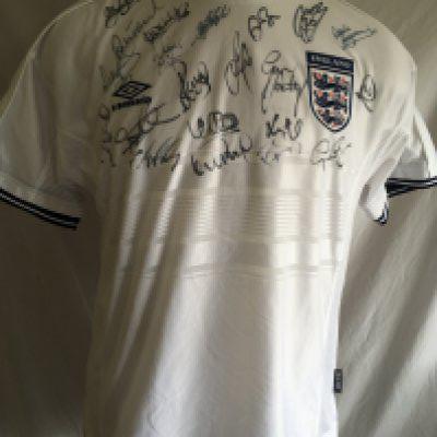 England 2000 Signed Football Shirt: Unused original shirt from 2000 signed by around 20 players including manager for the last ever England match at Wembley Keegan and current manager Southgate. Genuine autographs also from Rio Ferdinand Gary Neville Tony Adams Steve Gerrard and David Beckham.