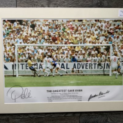 Pele + Banks Signed Football Print: In mount measuring 27 x 20 inches with COA from leading dealer A1 Sporting Memorabilia. Depicts the scene of Pele heading towards goal and Banks about to save at the 1970 World Cup. Print is named The Greatest Ever Save.