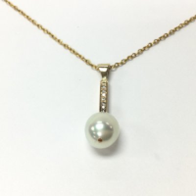 A pearl pendant set in gold with small diamonds. Comes with a chain which is not gold. Postage B