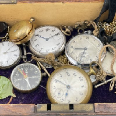 A box of interesting items to include silver watches, compass etc. Postage category B.