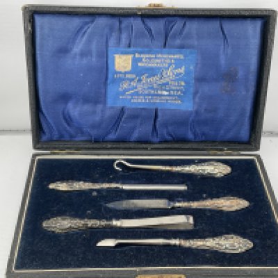 A boxed silver manicure set. Postage category B.