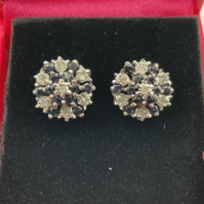A pair of 9ct diamond and sapphire earrings. Postage category A.