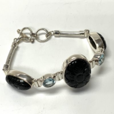A sterling silver Obsidian and blue topaz bracelet (A)