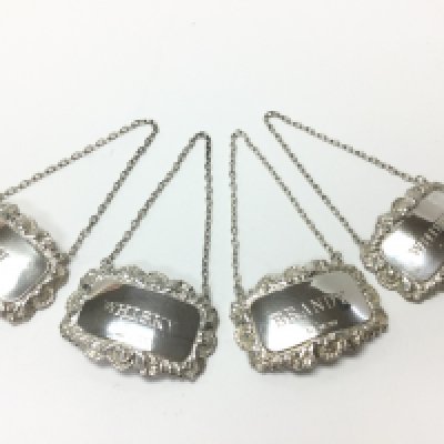 Four silver hallmarked decanter labels. Postage category A