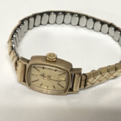 A ladies 9carat gold cased Omega wrist watch with a replacement metal strap.