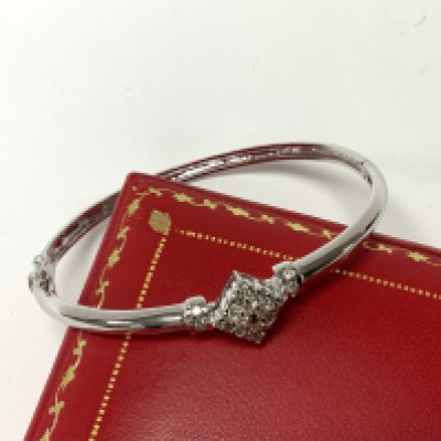 A good 9ct white gold bangle inset with pattern of diamonds. (A) total weight 13.24g.