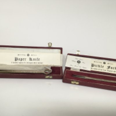 A silver paper knife and silver Pickle folk (2)