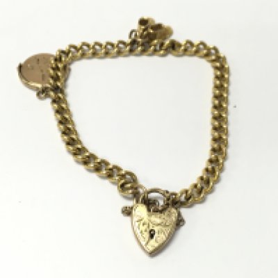 A 9ct gold charm bracelet with charms. 13.28g Postage A