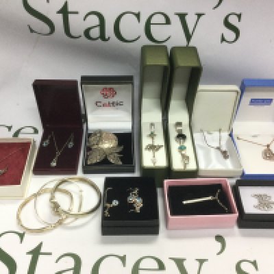 A tin of silver and costume jewellery comprising rings, bangles, necklaces, earrings etc.