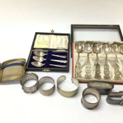 A silver cigarette case napkin rings silver Chinese spoons etc. Postage B