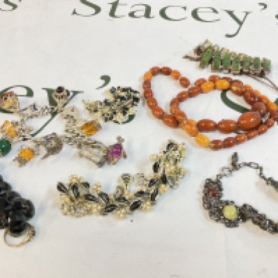 A collection of jewellery including a 9ct gold ring, a silver charm bracelet, a 9ct gold locket heart pendant and other jewellery. Postage category A