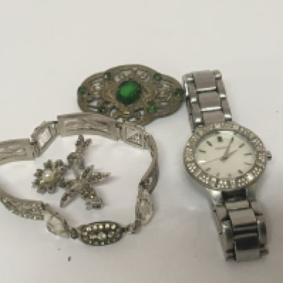 A designer ladies DKNY watch two brooches and a bracelet. NO RESERVE