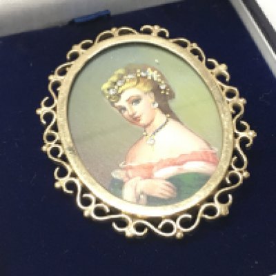 A 9ct gold miniature portrait brooch , 12.7g. Postage category a