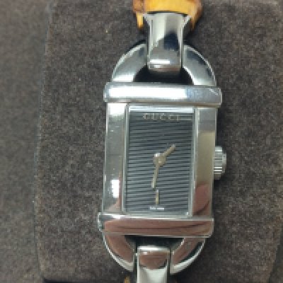 A Gucci ladies bamboo watch with box and papers. Seen working. Postage B