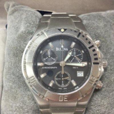 A Bulova stainless steel Chronograph with black dial. Comes with box and papers and seen working. Postage B