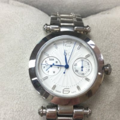 A GC ladies watch in stainless steel. Round face with white / silver dial with box and cards. Seen running. Postage B