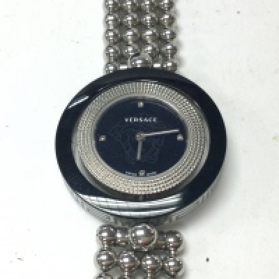 A Versace ladies watch with spinning bezel and round face with black dial. Comes with box. Postage B