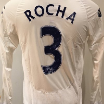 Portsmouth 2009 - 2010 Match Worn Football Shirt:  White long sleeve shirt with Premier League badge to sleeves. Rocha 3 to rear. Signed to front by the player. Some wear to number and staining to rear.