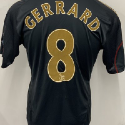 Liverpool 2009 - 2010 Match Worn Signed Football Shirt: Black Carlsberg Adidas short sleeve shirt with gold and red trim. Number 8 Gerrard to rear. Signed and dedicated to front by Gerrard.