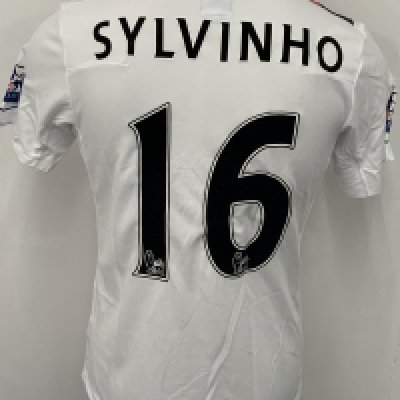 Manchester City 2009 - 2010 Sylvinho 3rd Kit Match Issued Football Shirt: White with red and black slash short sleeve Umbro shirt from 1st season of Etihad Sponsorship. Premier League badging to sleeve and Sylvinho 16 to rear. 